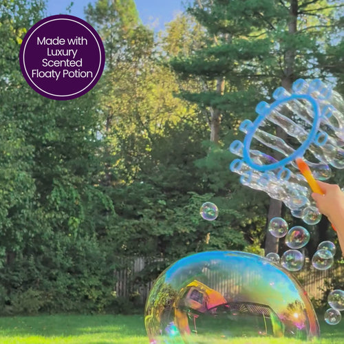 Luxury Scented Floaty Potion in action, creating a stream of colorful, iridescent floating bubbles in a sunny backyard.